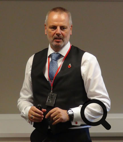 Man Standing in Front of Chairs and People